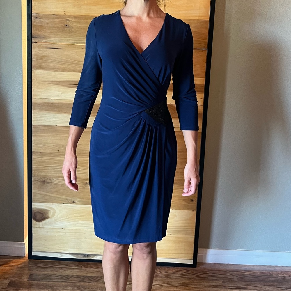 Deep blue faux wrap dress with faux leather detailing on one side.